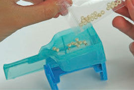 Beads being poured into tool
